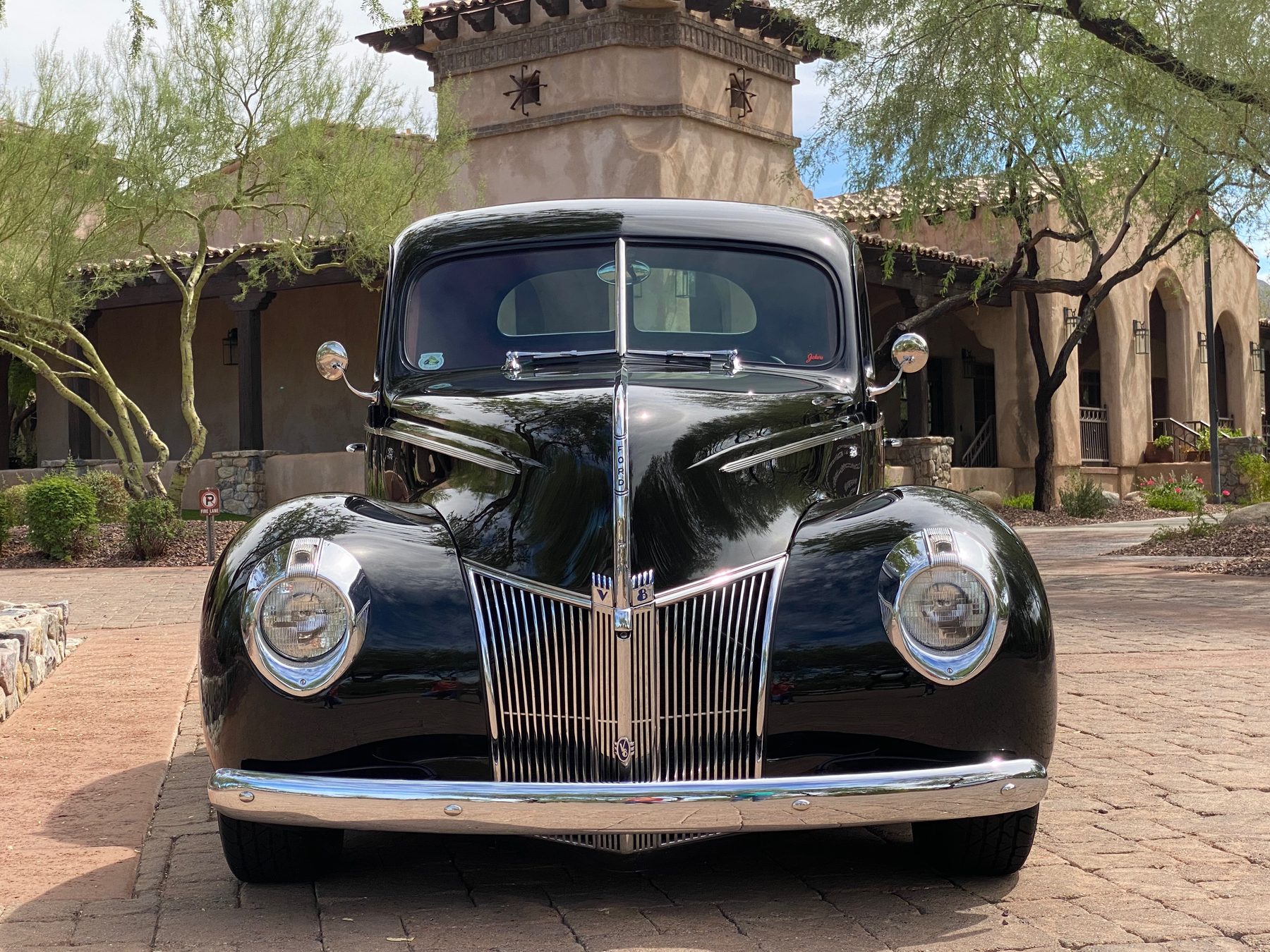 Straight-on front view with chrome grille and V8 badges