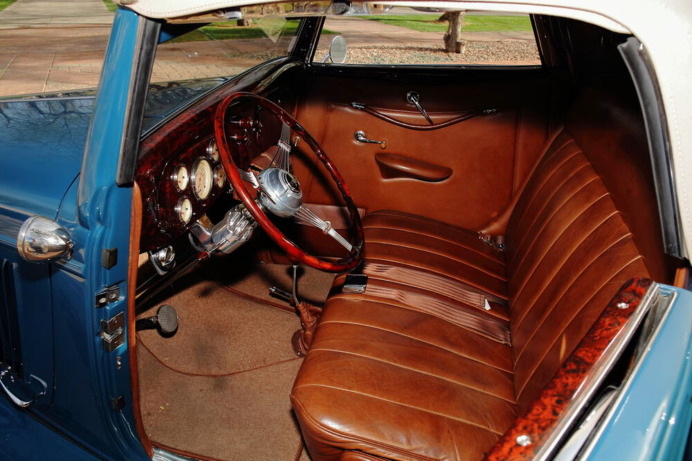 Full interior with banjo wheel and distressed leather bench, top up