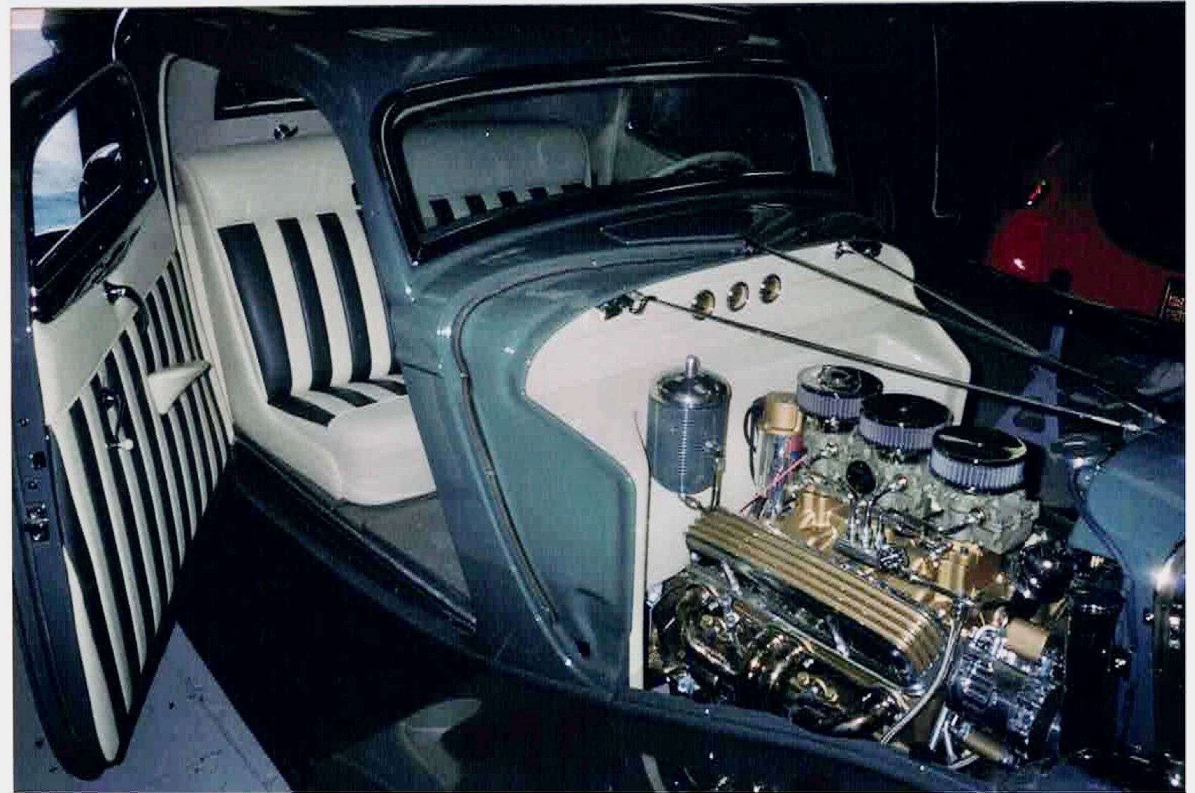 Period photo of the interior and engine bay during an earlier build, black and white striped seats