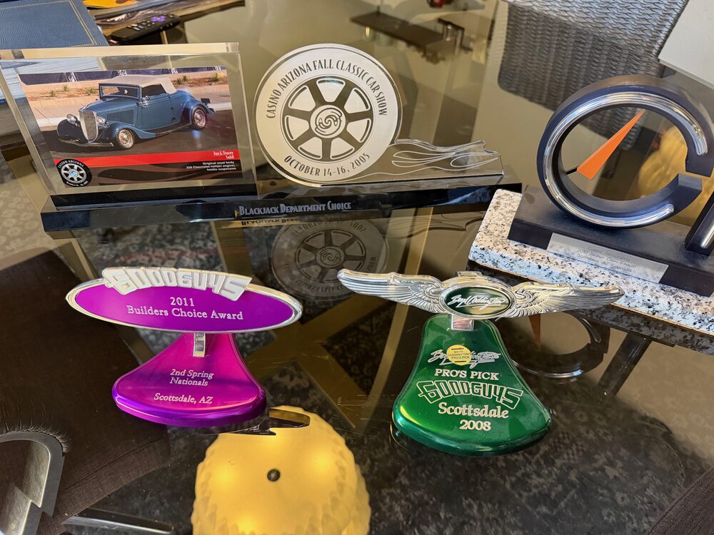Display of show trophies and awards including Goodguys Builders Choice Award, Boyd Coddington's Pro's Pick, and Classic Instruments Trophy Dash Finalist